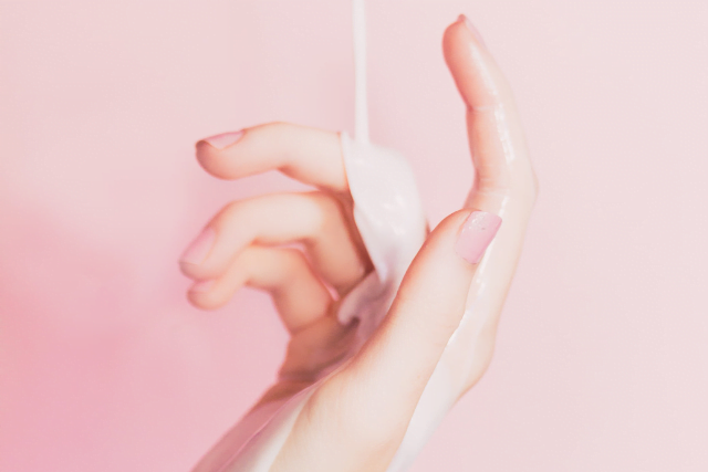 lotion being poured on woman's hand